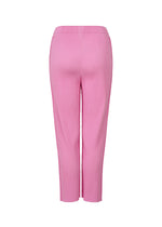 The FINE KNIT PLEATS COLOR 2 pants by me ISSEY MIYAKE are pink, high-waisted, ankle-length straight pants with a ribbed texture and fine knit pleats, shown from the back against a white background.