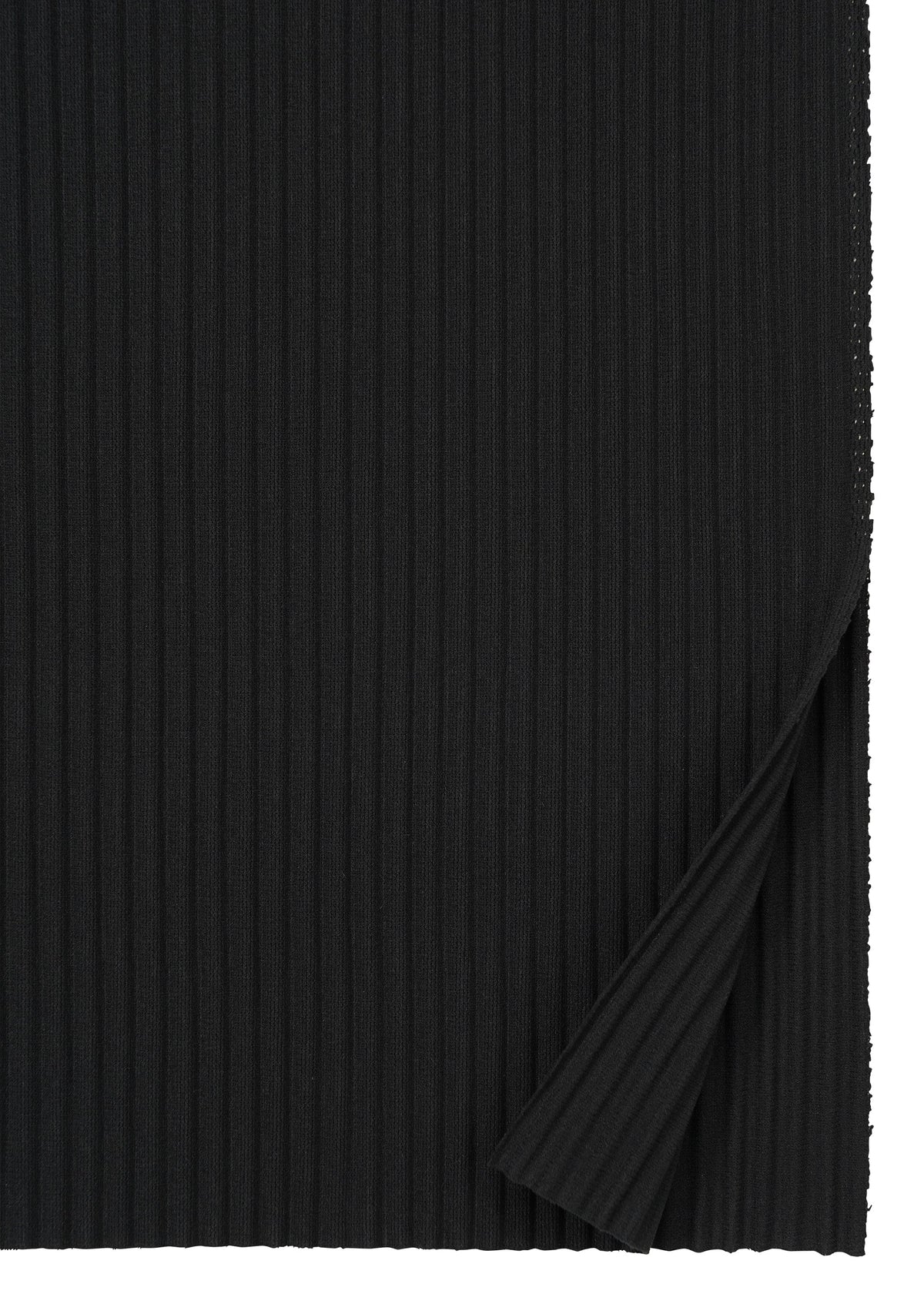 Close-up of FINE KNIT PLEATS BLACK by me ISSEY MIYAKE: black ribbed fabric with vertical textured lines, perfect for a pleated knit skirt. A corner is folded over, showing the matching underside. view 3 of 6