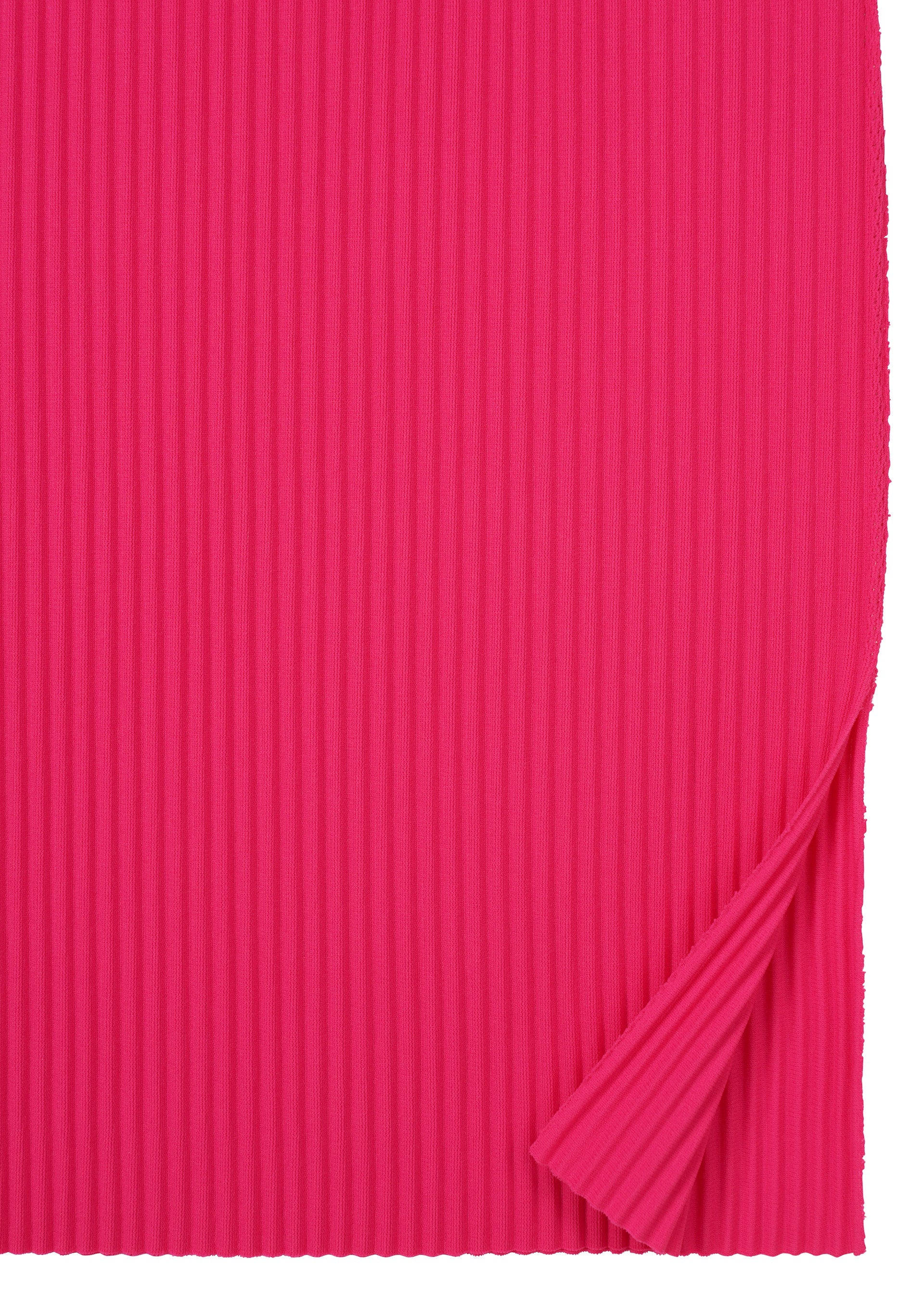 Zoomed view A sheet of FINE KNIT PLEATS COLOR 1 by me ISSEY MIYAKE in bright pink, with vertical ribbing like a pleated dress and a small lower right corner folded up to reveal matching texture beneath.