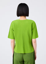 A person with a straight, chin-length black bob is seen from the back wearing the ROUND PLEATS short-sleeved knit top and matching pants in bright green by me ISSEY MIYAKE, set against a plain light background.