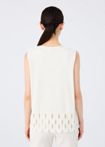 A woman with long dark hair in a low ponytail is seen from behind, wearing the APERTURE PLEATS sleeveless top by me ISSEY MIYAKE, featuring oval cut-outs and paired with matching white pants against a plain background.