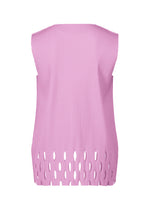 The back of the APERTURE PLEATS top by me ISSEY MIYAKE is shown—sleeveless, light pink with a high neckline, uneven hem, large oval cutouts along the bottom edge, and crafted from lightweight pleated knit for texture.