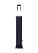 A dark blue, ribbed, cylindrical neoprene TRUNK PLEATS BAG 12 by me ISSEY MIYAKE features a unique looped handle at the top, making it ideal for holding or carrying items. Its vivid color and distinctive design ensure that it is both stylish and practical. - NAVY （no.75）