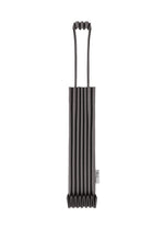 The TRUNK PLEATS BAG 12 by me ISSEY MIYAKE, a black accordion-style mini tote with two looped handles and a small white side tag, is showcased strikingly against a white background. - CHARCOAL （no.14）