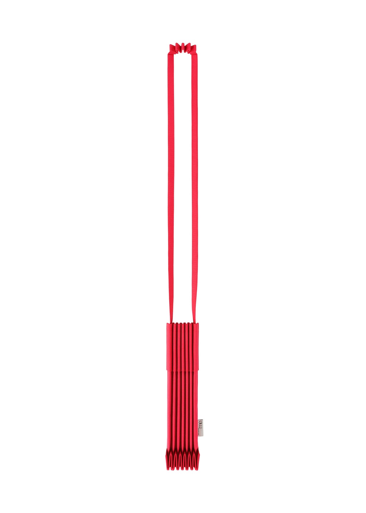 A striking red, rectangular TRUNK PLEATS BAG 12 by me ISSEY MIYAKE with a long strap is displayed vertically against a white background. This shoulder bag showcases an accordion-style pleated design and features a small tag on the side. view 10 of 16