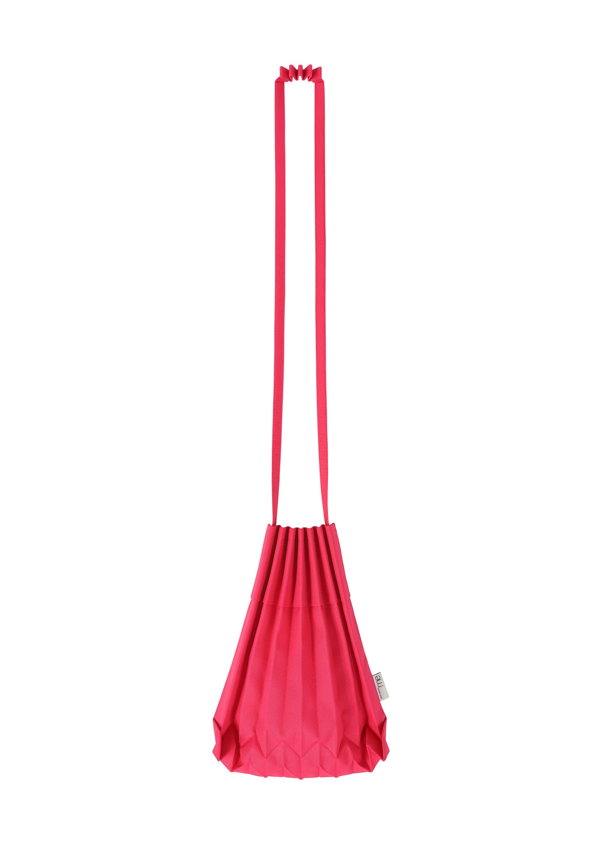 Zoomed view The TRUNK PLEATS BAG 12 by me ISSEY MIYAKE is crafted from bright pink pleated fabric and comes with a long, matching strap. This bold shoulder bag showcases a unique geometric, fan-like silhouette and features a small side tag. The bag is displayed against a plain white background.