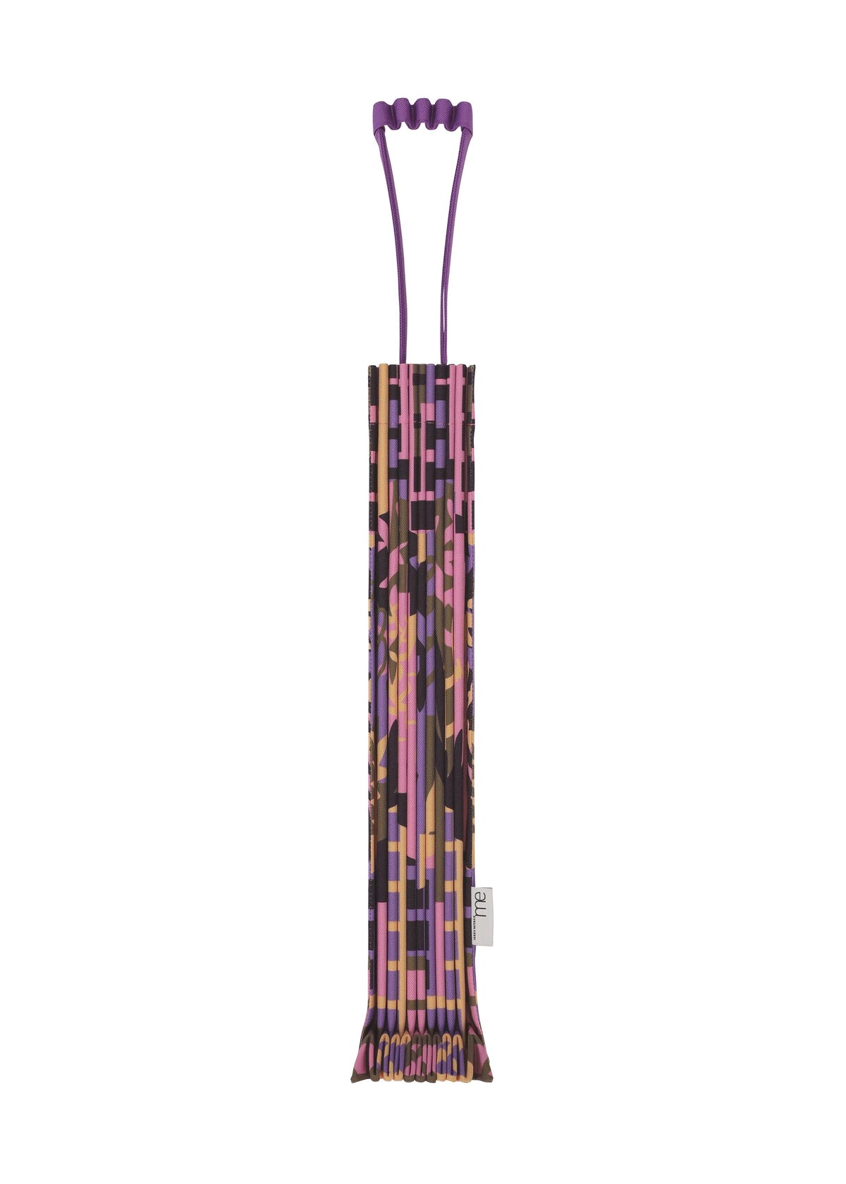 The BUILDING TRUNK PLEATS BAG by me ISSEY MIYAKE—a rectangular tote featuring purple handles and a mix of pink, brown, and gold geometric prints—stands upright against a white background. view 2 of 8