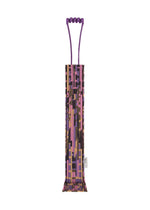 The BUILDING TRUNK PLEATS BAG by me ISSEY MIYAKE—a rectangular tote featuring purple handles and a mix of pink, brown, and gold geometric prints—stands upright against a white background. - PINK-HUED （no.27）