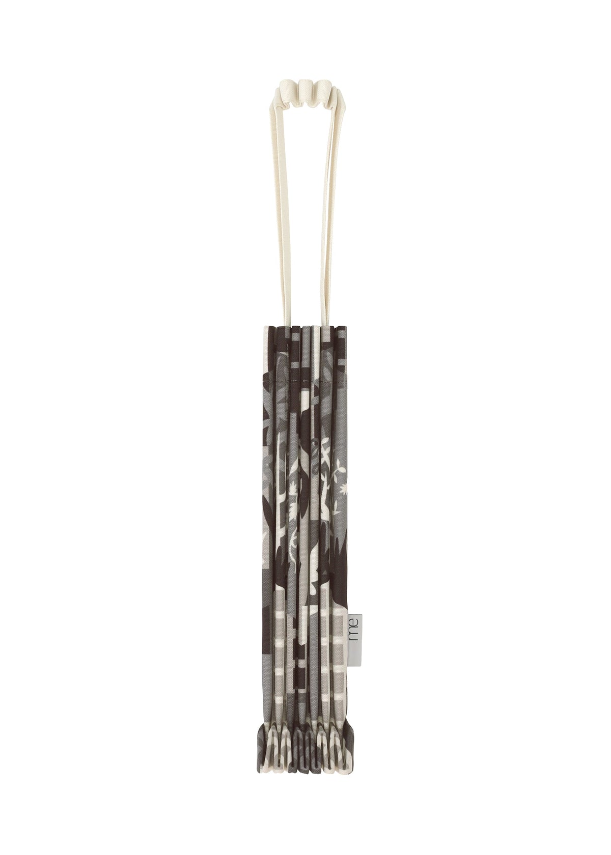 BUILDING TRUNK PLEATS BAG by me ISSEY MIYAKE in folded gray and white patterned design, featuring a unique handle and a white strap, displayed from above against a white background. view 1 of 8