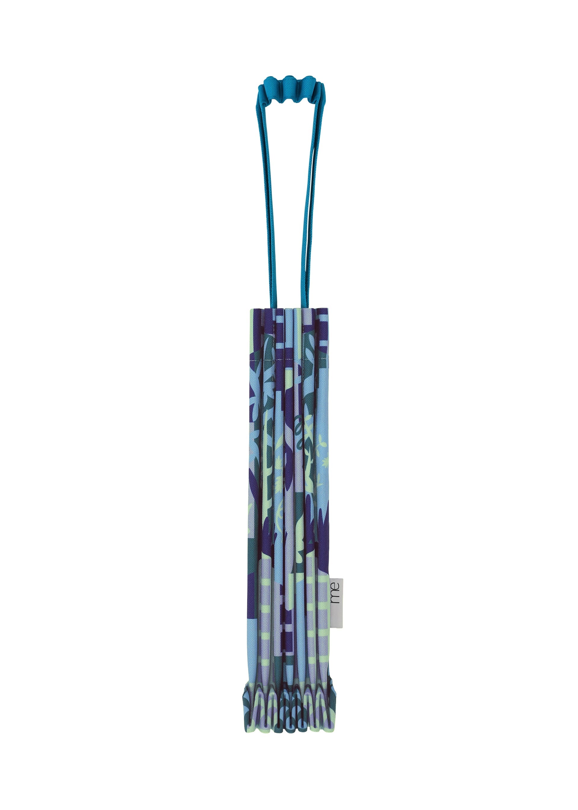 Zoomed view A folded, patterned BUILDING TRUNK PLEATS BAG by me ISSEY MIYAKE, featuring a unique handle and a multicolored blue, purple, and green camouflage-inspired design—perfect for urban adventures—stands upright on a white background. - BLUE-HUED （no.78）