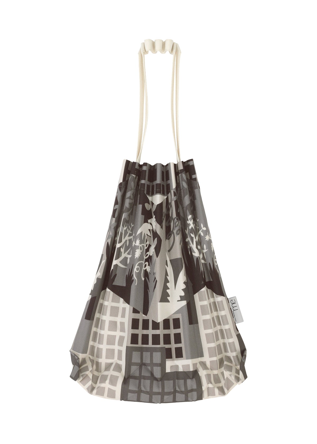 The BUILDING TRUNK PLEATS BAG by me ISSEY MIYAKE is a mini tote bag with distinct cream-colored handles, adorned with an abstract grayscale cityscape and plant motif inspired by urban farming. A small tag accents the side of the bag. view 5 of 8