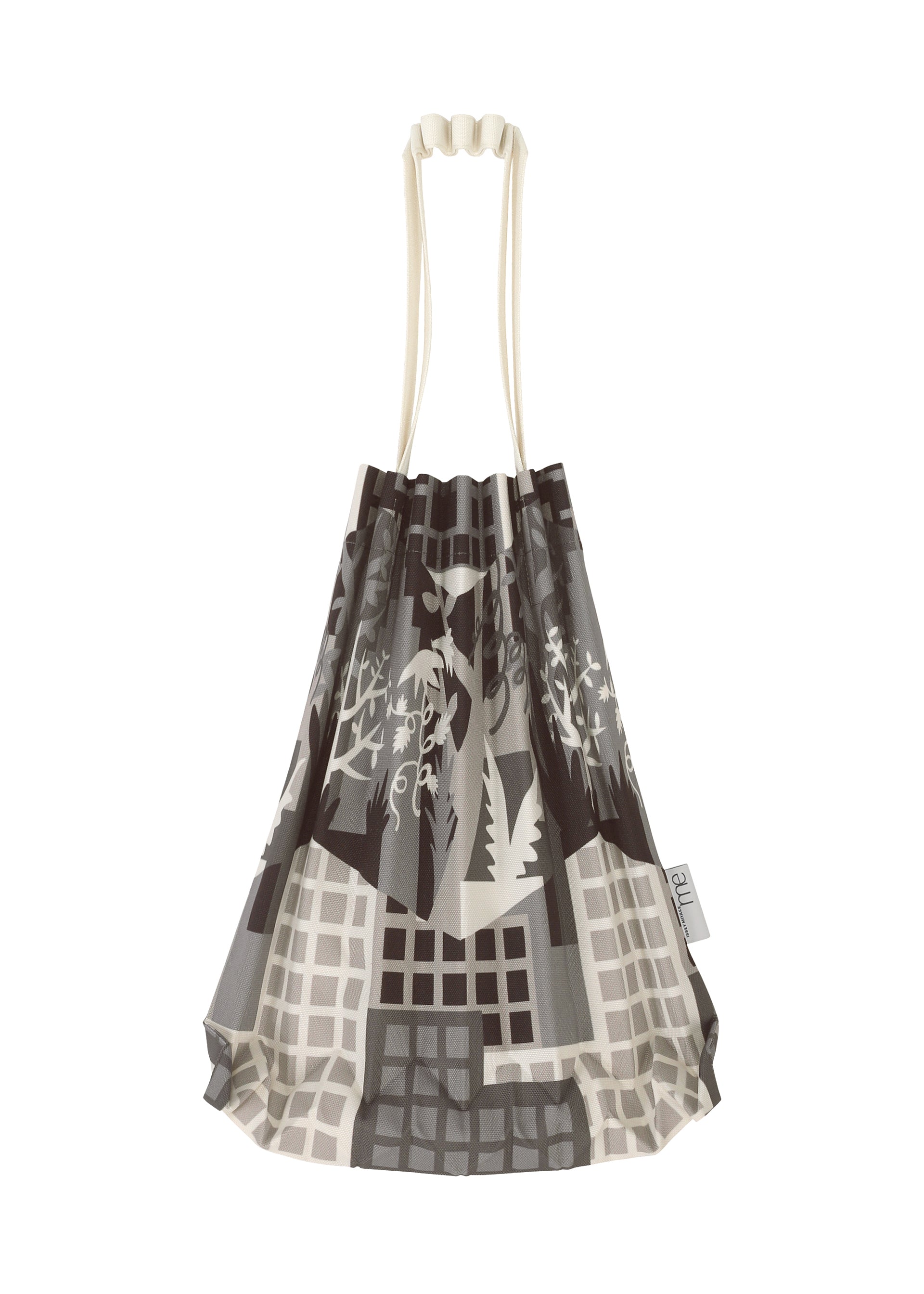 Zoomed view The BUILDING TRUNK PLEATS BAG by me ISSEY MIYAKE is a mini tote bag with distinct cream-colored handles, adorned with an abstract grayscale cityscape and plant motif inspired by urban farming. A small tag accents the side of the bag.