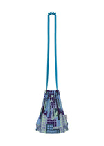 Introducing the BUILDING TRUNK PLEATS BAG by me ISSEY MIYAKE—a compact drawstring shoulder bag featuring striking blue straps and a vibrant geometric pattern in shades of blue, green, and purple set against a crisp white background. Its distinctive handle design blends style with practicality, making it the ideal accessory for carrying your essentials whether you’re navigating city streets or tending to your urban garden.