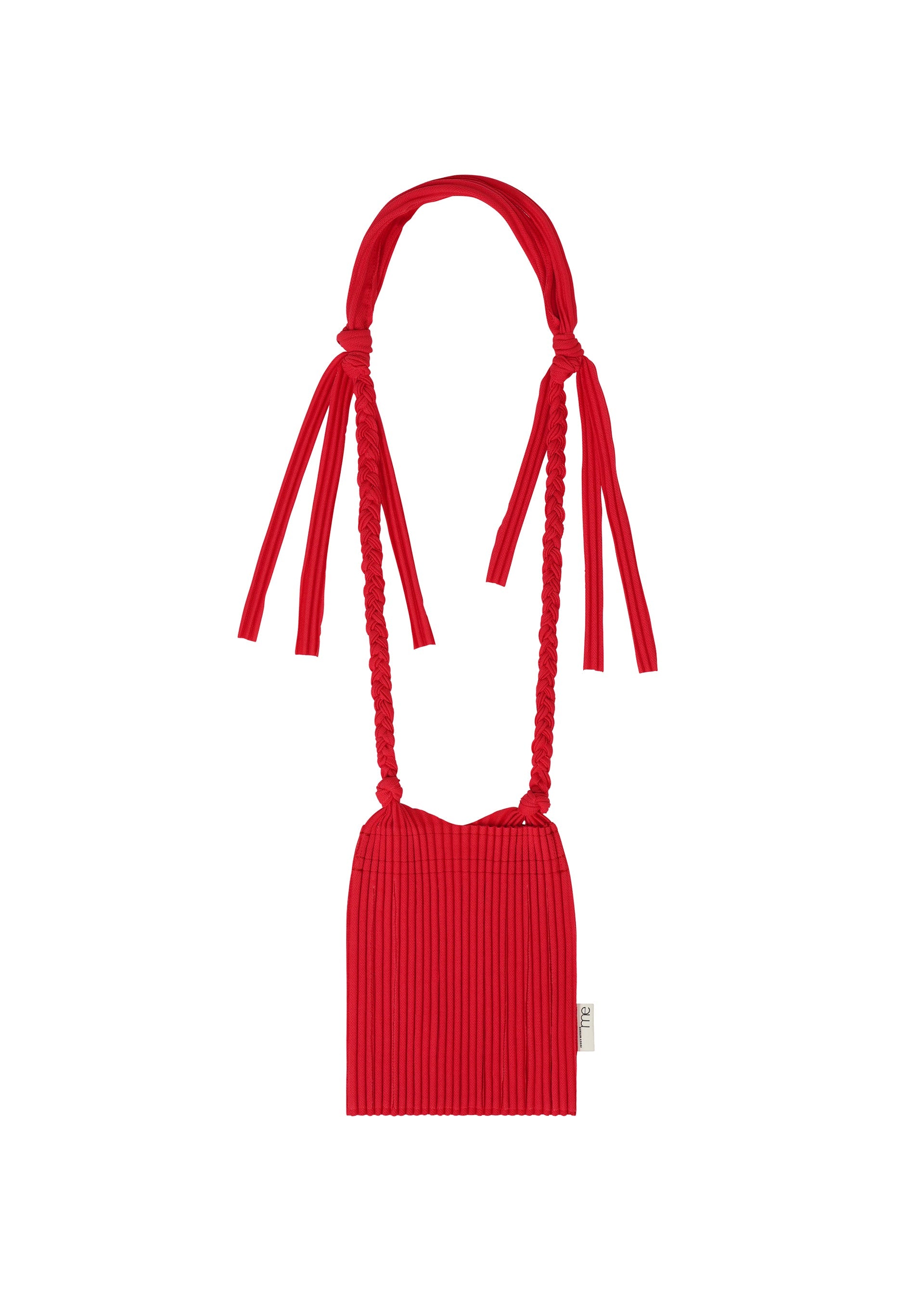 Zoomed view The LEAF PLEATS BAG by me ISSEY MIYAKE is a small, basket-inspired accessory crafted from bright red pleated fabric. It features a long, braided strap, two tied bows at the top, and a distinctive small white tag attached to the side. - RED （no.24）