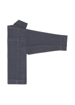 The FLAT DENIM jeans by me ISSEY MIYAKE, made from dark blue recycled polyester denim, are folded with one leg extended and the waistband at the top left, highlighting their realistic denim texture.