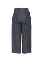 The FLAT DENIM pants by me ISSEY MIYAKE are dark wide-leg trousers in recycled polyester denim with a high, ruffled elastic waistband and front seams, shown against a plain white background.
