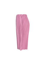 The TOWER PLEATS BOTTOM by me ISSEY MIYAKE is a knee-length, pleated pink skirt with an elastic waistband, reminiscent of handmade pleated shorts, shown from the side against a white background.