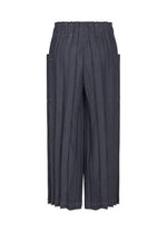 The DENIM PLEATS BOTTOM by me ISSEY MIYAKE features a wide-leg, high-waisted silhouette with an elastic waistband, prominent vertical hand-pleated detailing, and large side pockets, shown against a white background.