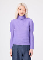 A person with light blonde hair is wearing the me ISSEY MIYAKE STRETCH PLEATS 3 lavender high-neck, long-sleeved sweater with subtle stretch pleats and dark pants, standing against a plain white background, facing forward and smiling softly.