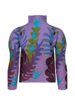 The JUNGLE turtleneck shirt by me ISSEY MIYAKE features a high-neck, long-sleeve design and displays a colorful abstract leaf pattern in green, blue, and maroon on a lavender background, shown from the back.