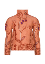 The PLANT sweater by me ISSEY MIYAKE is a high-neck, long-sleeve orange knit featuring abstract floral and geometric patterns in brown and purple tones, with a textured design that echoes sophisticated plant motifs. - VERMILION-HUED （no.38）