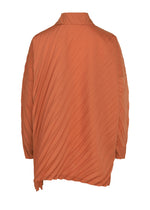The ANGLE PLEATS SHIRT by me ISSEY MIYAKE is an orange, long-sleeve jacket with pleats, shown from the back. It features diagonal textured lines and an asymmetrical hem, offering a versatile shirt-inspired design that effortlessly blends style and function.