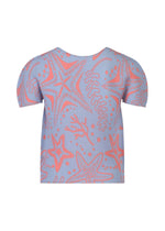 The STARFISH shirt by me ISSEY MIYAKE features a round neck, short sleeves, and a light blue background with pink starfish, seaweed, and coral patterns, shown against a plain white background.