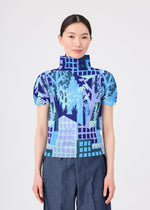 A person stands facing forward against a plain light background, wearing the BUILDING top by me ISSEY MIYAKE—a short-sleeve, high-neck design adorned with a blue, purple, and turquoise abstract forest pattern and delicate stretch pleats—paired with blue pants.