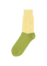 FRUITS SOCKS by me ISSEY MIYAKE: a unique single knit sock with an olive green foot and toe, and a pale yellow ribbed ankle and cuff. Displayed on a white background. - MELON （no.99）