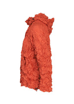 The MERINGUE PARKA by me ISSEY MIYAKE, crafted from bright orange recycled polyester with a crinkled, textured finish, is displayed in a side view against a plain white background. This lightweight, water-repellent jacket features a high collar and long sleeves.