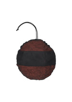 A round, red mesh bag with a black horizontal band and a drawstring closure—ideal for storing your MERINGUE PARKA by me ISSEY MIYAKE or other lightweight, packable jackets—isolated on a white background.