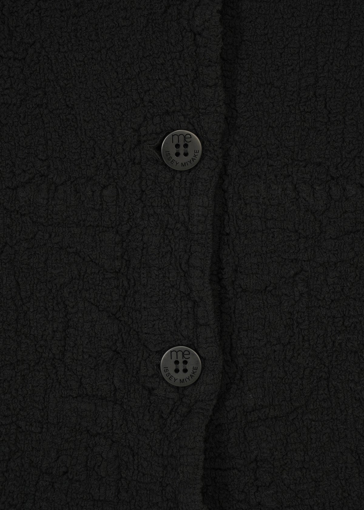Black textured, stretchy me ISSEY MIYAKE CAULIFLOWER JACKET featuring circular buttons embossed with brand text. view 4 of 7