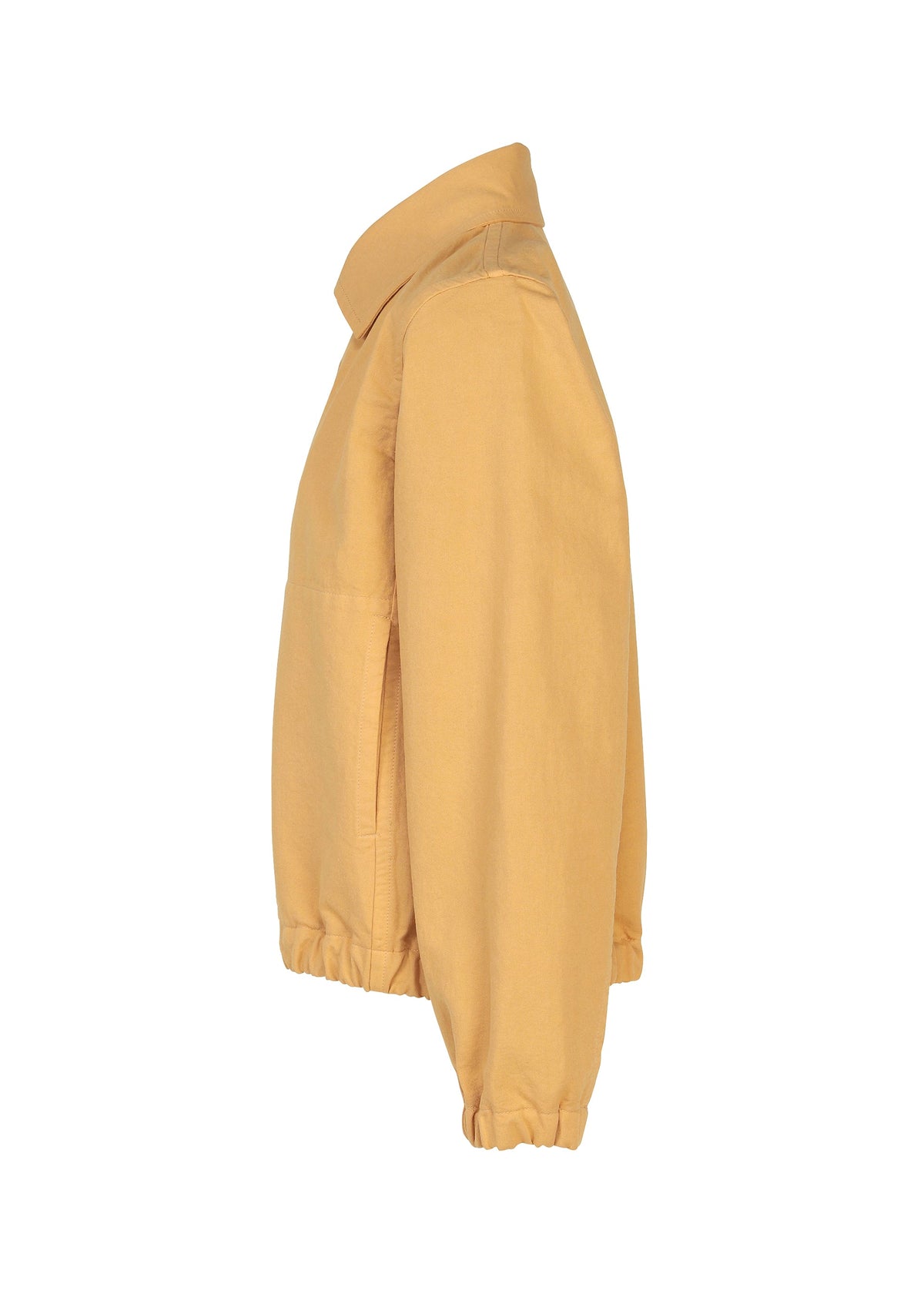 The PINA CLOTH jacket by me ISSEY MIYAKE is shown in a side profile view, featuring a light brown garment-dyed finish. It has a collar, elastic cuffs, and a gathered hem for a clean and simple look without any visible logos or patterns. view 4 of 8