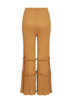 Introducing the FLARE SEE-THROUGH CREPE pants by me ISSEY MIYAKE: mustard yellow, high-waisted wide-leg trousers crafted from garment-dyed crepe fabric with a textured finish. These distinctive pants feature two horizontal ruffle accents on each leg and a subtly flared, ruffled hem that adds playful movement to the design.