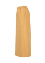 A long, straight, light orange PINA CLOTH skirt by me ISSEY MIYAKE, featuring an elastic waistband and shown from the side against a plain white background, pairs beautifully with a garment-dyed jacket for a stylish and cohesive look.