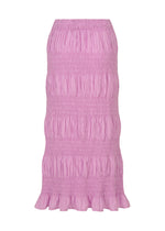 The SHRINK STRIPE skirt by me ISSEY MIYAKE is a pink, ankle-length cotton blend piece featuring horizontal ruching and a ruffled hem, crafted with a product-dyeing technique and shown against a white background.