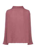 The POLYCOTTON CREPE by me ISSEY MIYAKE is a mauve, long-sleeved top with a small collar, made from a cotton-polyester blend and garment-dyed for a textured, slightly crinkled finish.
