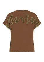 The LEAF TULLE CAULIFLOWER top by me ISSEY MIYAKE is a brown cotton, short-sleeved piece with green ruffled trim in a wavy design across the front and sleeves, highlighted by intricate tulle tape embroidery that accentuates its relaxed square silhouette. - BROWN （no.44）