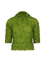 The MERINGUE TOP by me ISSEY MIYAKE is a textured green crushed pleat top with a crinkled surface, three-quarter sleeves, and a high gathered neckline, shown on a white background.