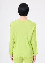 A person with short black hair is seen from behind, wearing a lime green SEE-THROUGH CREPE COLOR set by me ISSEY MIYAKE. The long-sleeved, textured top and matching pants are product-dyed. The background is plain white.