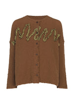 Here’s a rewritten version using your product data: The LEAF TULLE CAULIFLOWER cardigan by me ISSEY MIYAKE is a brown, textured, button-up cotton piece with a loose fit and olive green wavy ruffle detailing across the chest, accented by delicate tulle tape embroidery for added dimension. - BROWN （no.44）