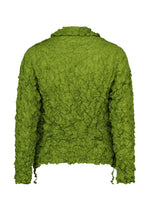 The MERINGUE TOP by me ISSEY MIYAKE is a green, long-sleeve polyester top with a crinkled texture and crushed pleats, shown from the back on a white background.