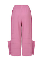 The image displays the back view of the me ISSEY MIYAKE FINE KNIT PLEATS BOTTOM 1: a pink pair of high-waisted pants featuring wide legs, rectangular side panels that extend from the hem, and soft fine-knit pleats for an overall textured look. The fabric is detailed with horizontal laser-cut accents.