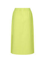 The MESH PLEATS skirt by me ISSEY MIYAKE is a knee-length, high-waisted pleated knit in bright yellow-green with a soft feel and simple elastic waistband, shown against a plain white background.