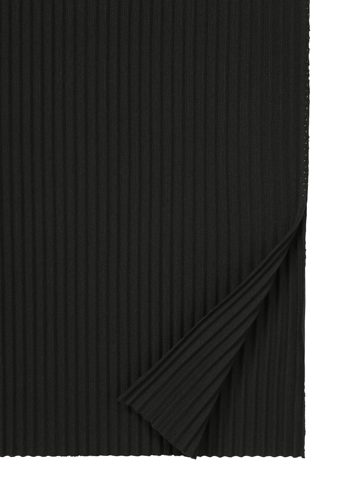 A piece of black FINE KNIT PLEATS fabric by me ISSEY MIYAKE, with one corner folded upward to reveal the textured underside. The soft material features fine, evenly spaced vertical knit ridges. view 4 of 7