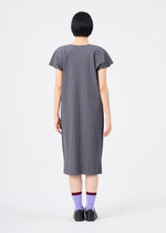 A person with short black hair, wearing the me ISSEY MIYAKE FINE KNIT PLEATS COLOR 2 gray, short-sleeved pleated dress and purple socks with black shoes, stands facing away against a plain white background.