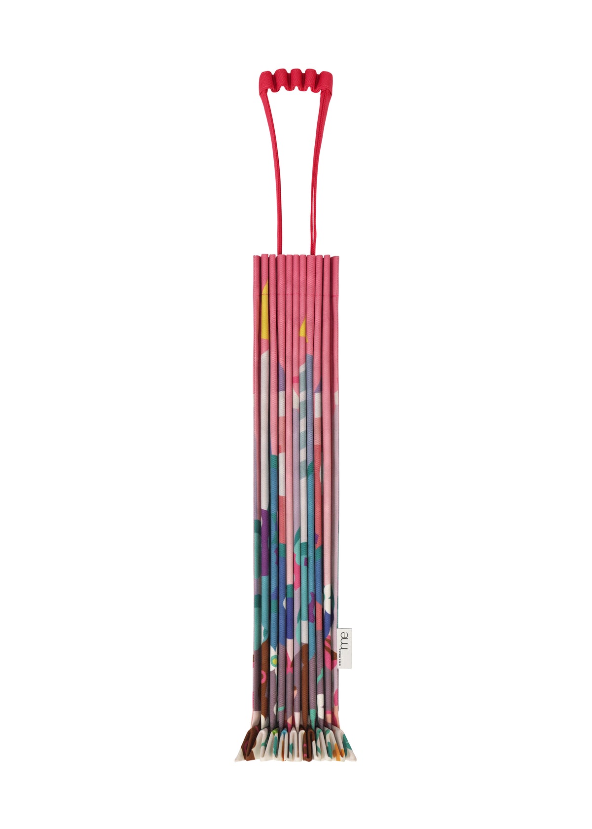 The TRUNK PLEATS BAG / NY by me ISSEY MIYAKE features a red handle and vibrant pink, blue, and green geometric patterns—compact and upright, ideal for a Madison Square Park stroll. view 3 of 6