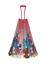 A vibrant TRUNK PLEATS BAG / NY by me ISSEY MIYAKE, featuring red handles and playful floral, tree, and bear motifs on pink—ideal for a stroll in Madison Square Park.
