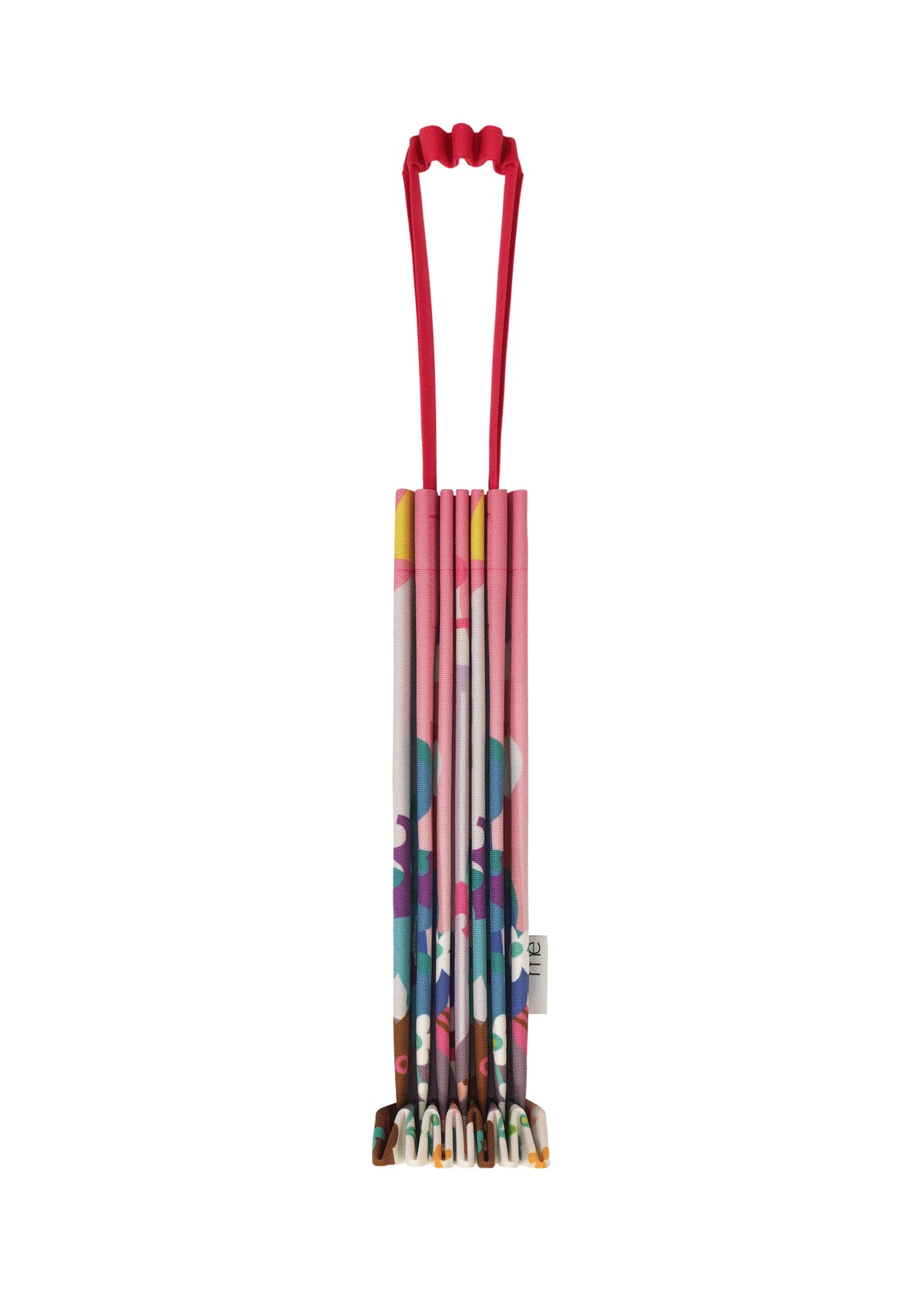Zoomed view Colorful, patterned me ISSEY MIYAKE TRUNK PLEATS BAG / NY folded into a compact vertical mini tote, featuring a red elastic handle at the top, shown against a white background. - PINK-HUED （no.27）