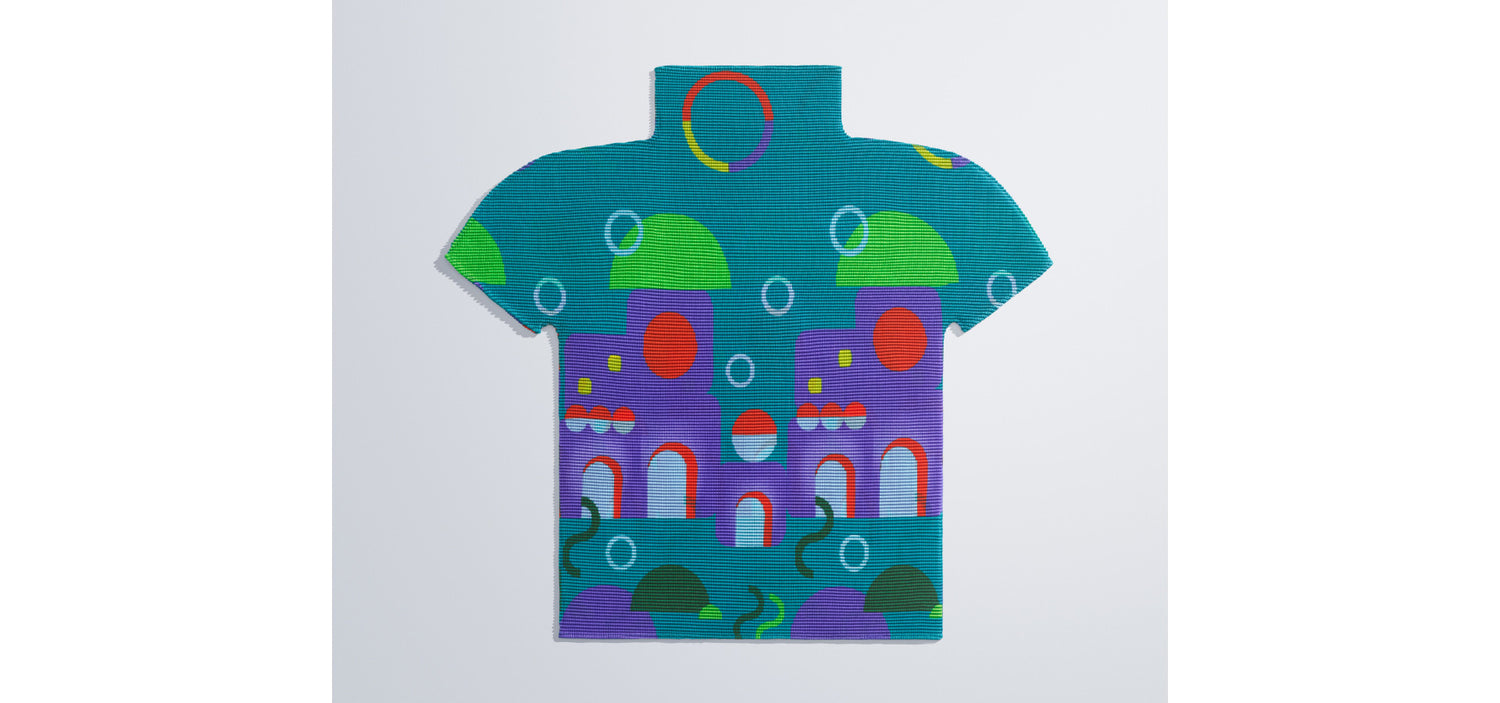 Colorful pleated t-shirt with abstract designs on a light gray background